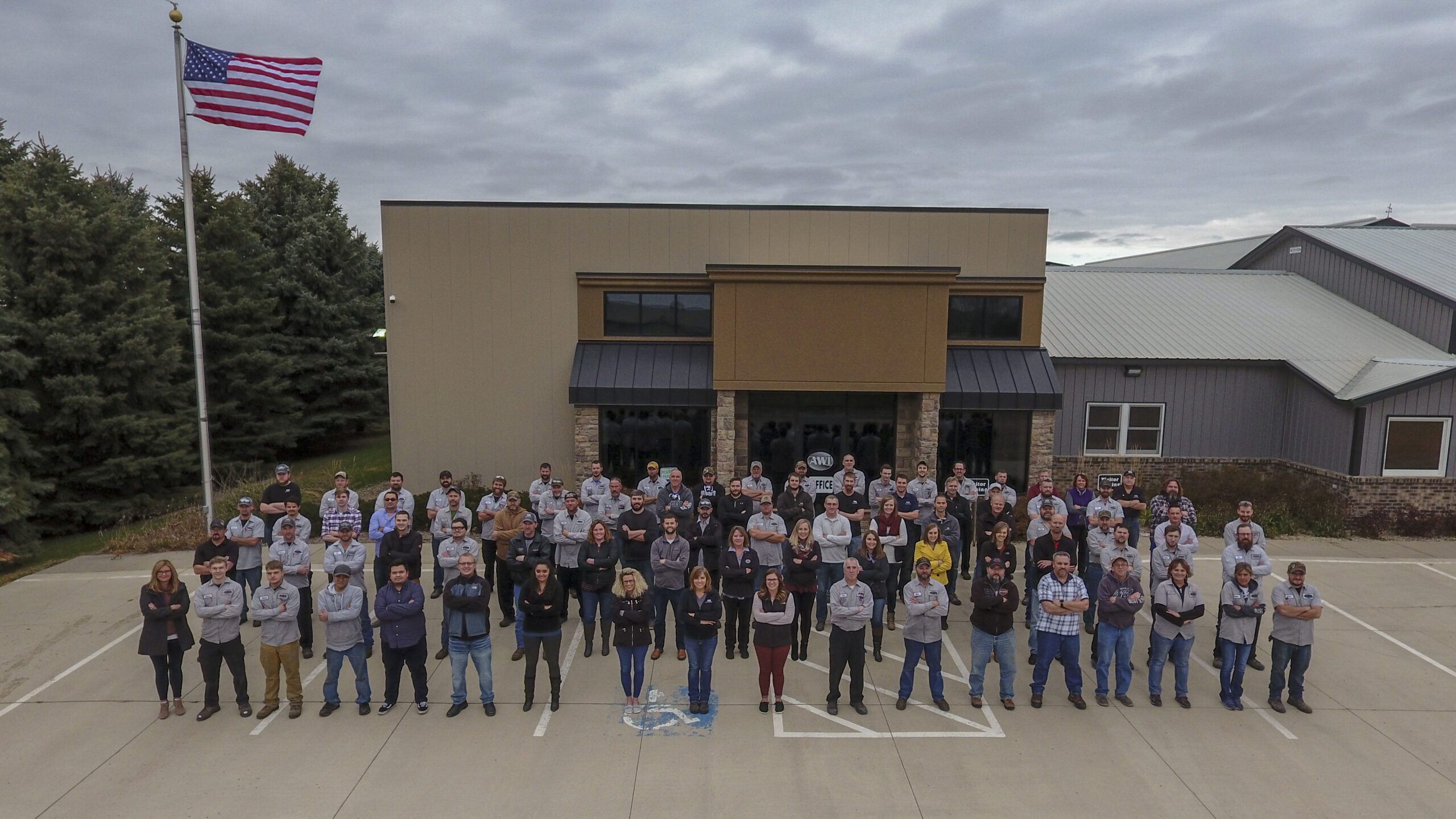 AWI Employees Standing in Front of Their Building